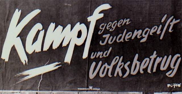 Antisemitisches Plakat 1938. In dem Ausschnitt dieses Plakats steht: "Kampf gegen Judengeist und Volksbetrug". Darüber ist zu lesen: "Jüdische Wucherpreise und Arisches Geschäft sind unvereinbar!"